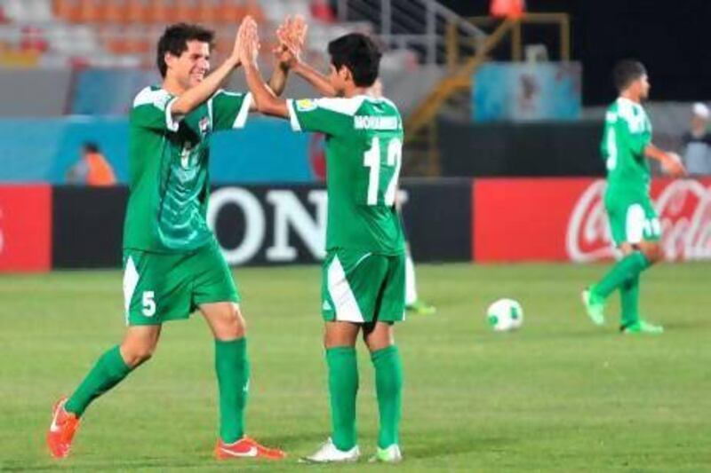 Iraq's Ali Faez celebrates with Mohamed Jabba Arebat after scoring against England.