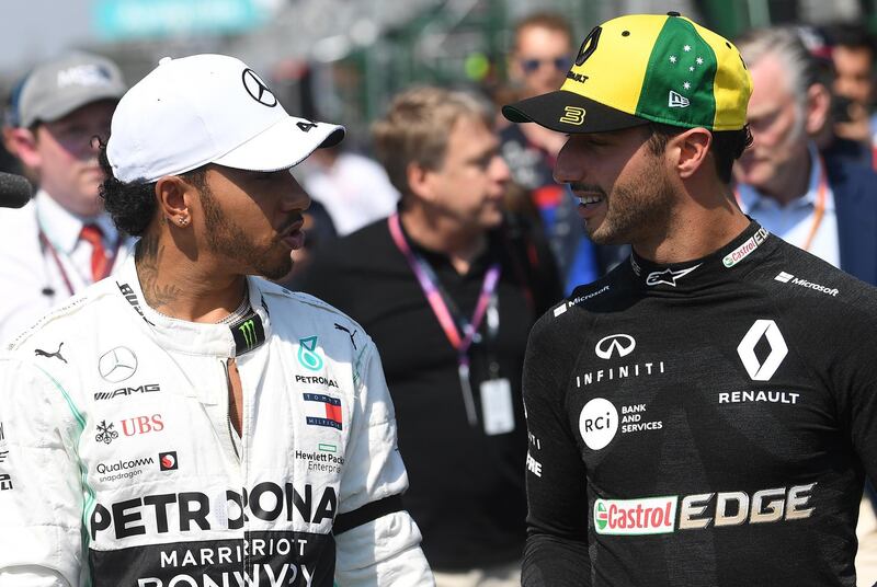 Lewis Hamilton of Britain (L) and Daniel Ricciardo of Australia (R) converse ahead of the start of the 2019 Formula One Grand Prix of Australia at the Albert Park Grand Prix Circuit in Melbourne, Australia.  EPA