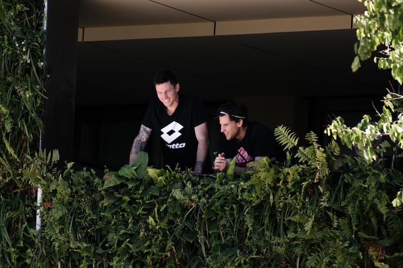 Support staff appear with Dominic Thiem on the balcony of the M Suites, where some Australian Open competitors are currently under quarantine after testing positive for Covid-19, in North Adelaide, Australia. EPA