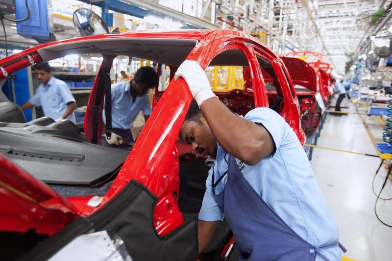 Employees work on the final assembly of cars at the Ford facility in Chennai. Bloomberg