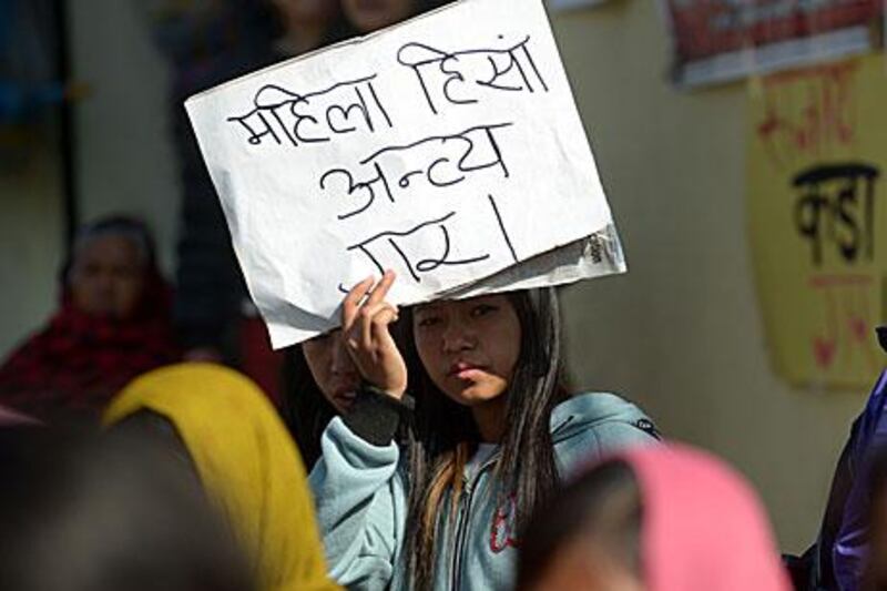 A Nepalese activist protests in Kathmandu for better women's rights following the reported rape of a maid returning from Saudi Arabia by government officials.