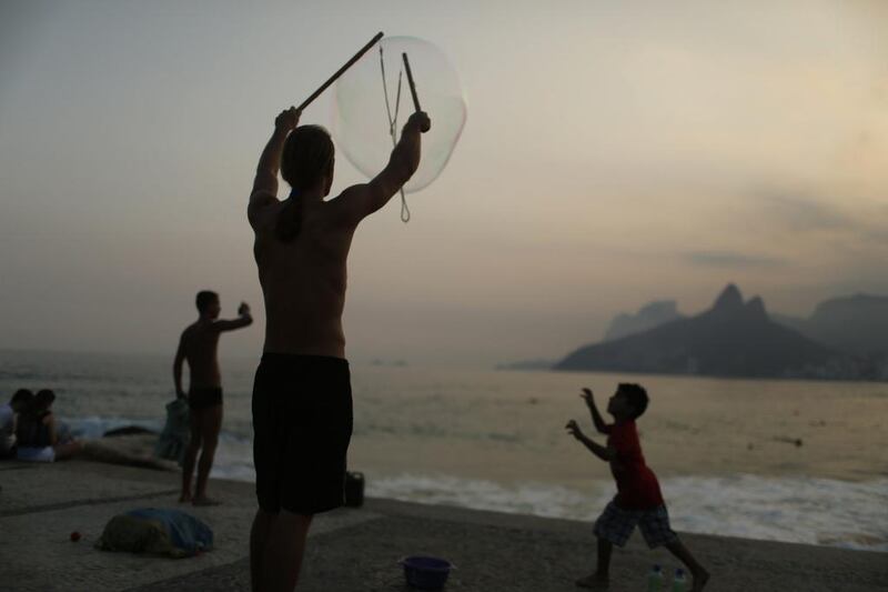 A man makes giant bubbles at the Ipanema beach in Rio de Janeiro. Pilar Olivares / Reuters