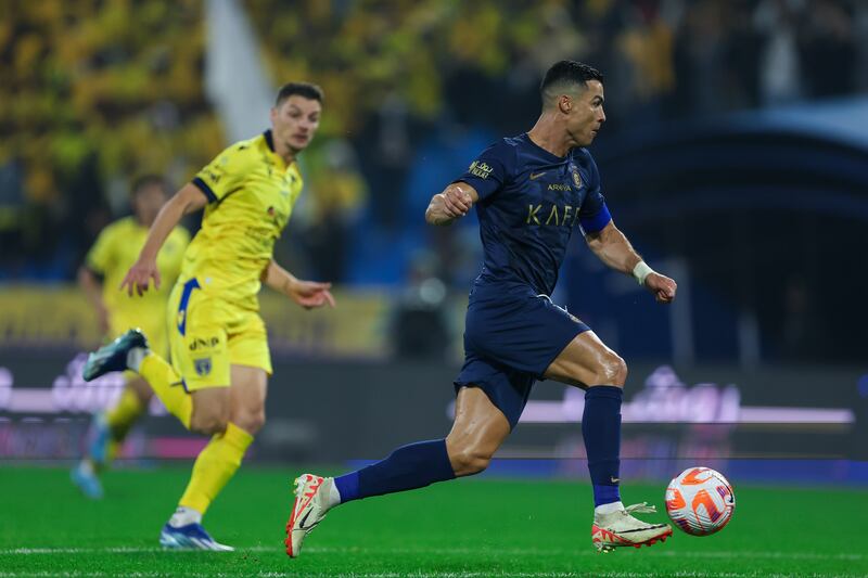 Cristiano Ronaldo runs with the ball during Al Nassr's game against Al Taawoun. Getty Images