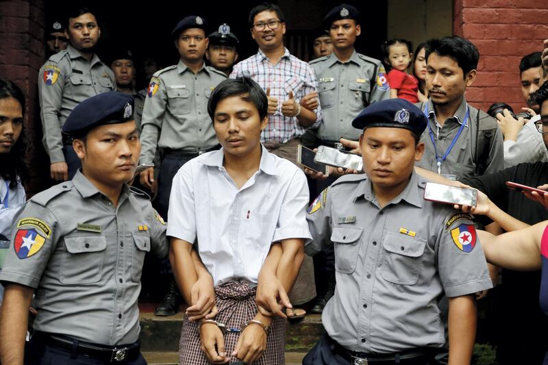 Detained Reuters journalist Kyaw Soe Oo and Wa Lone are escorted by police as they leave after a court hearing in Yangon, Myanmar, August 20, 2018. REUTERS/Ann Wang SEARCH "POY GLOBAL" FOR FOR THIS STORY. SEARCH "REUTERS POY" FOR ALL BEST OF 2018 PACKAGES. TPX IMAGES OF THE DAY.