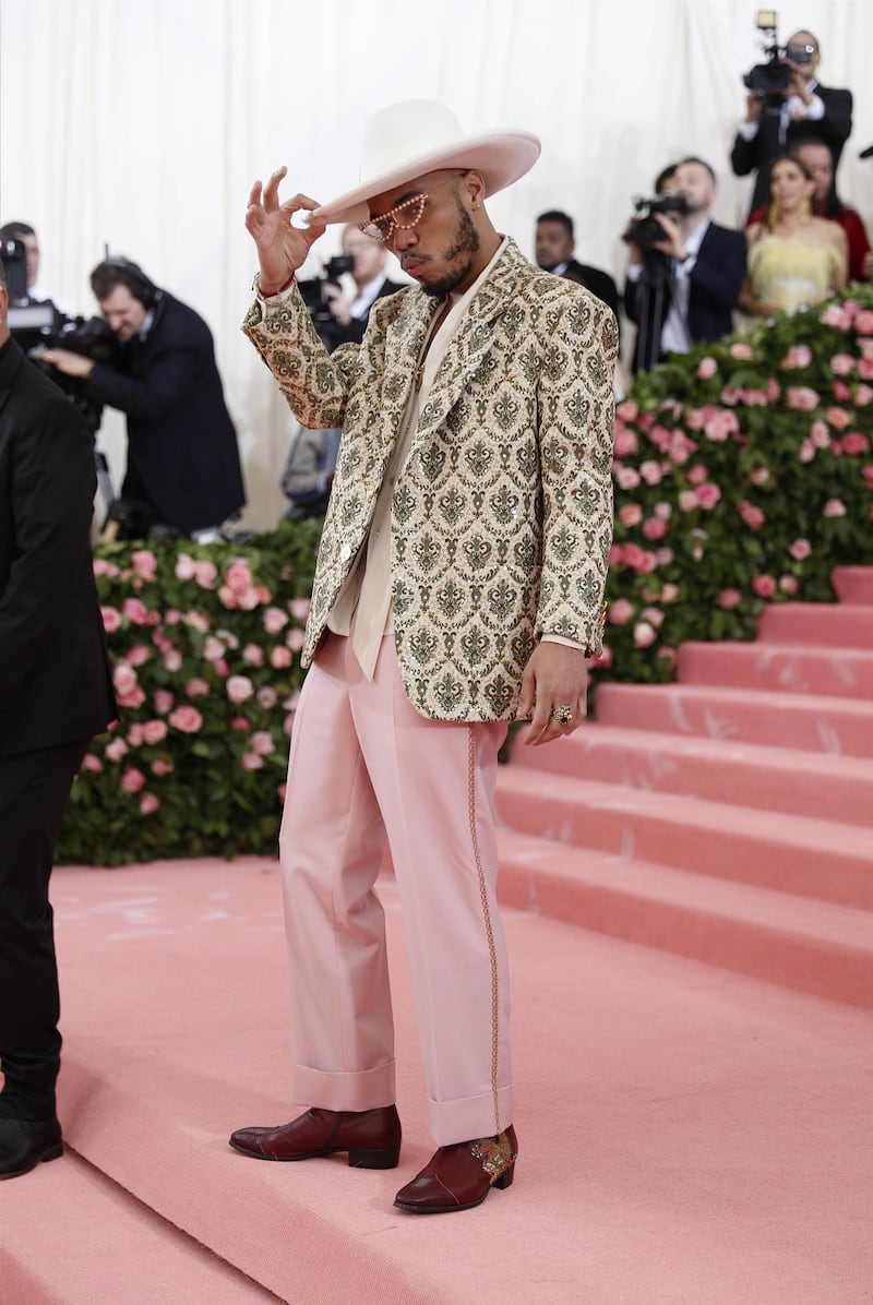 Rapper Anderson Paak arrived in a brocade jacket and pink trousers. The half moon glasses and felted hat was a nice touch. EPA