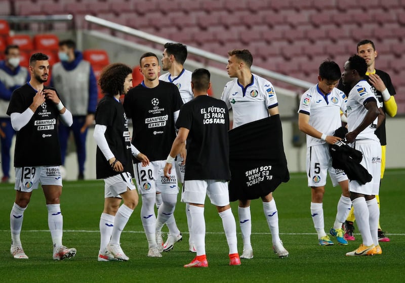 Getafe players are seen wearing a t-shirt with a message against the European Super League before the match against Barcelona. Reuters