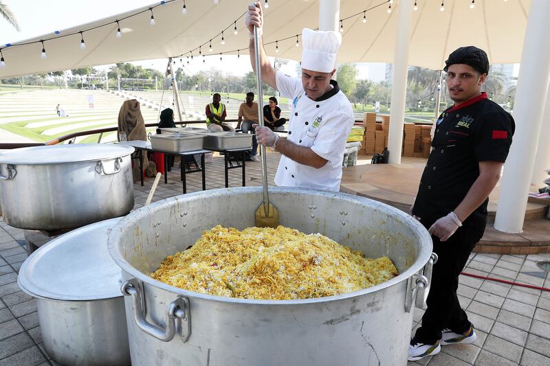 A chef prepares a giant vat of biryani to be served up. Pawan Singh / The National