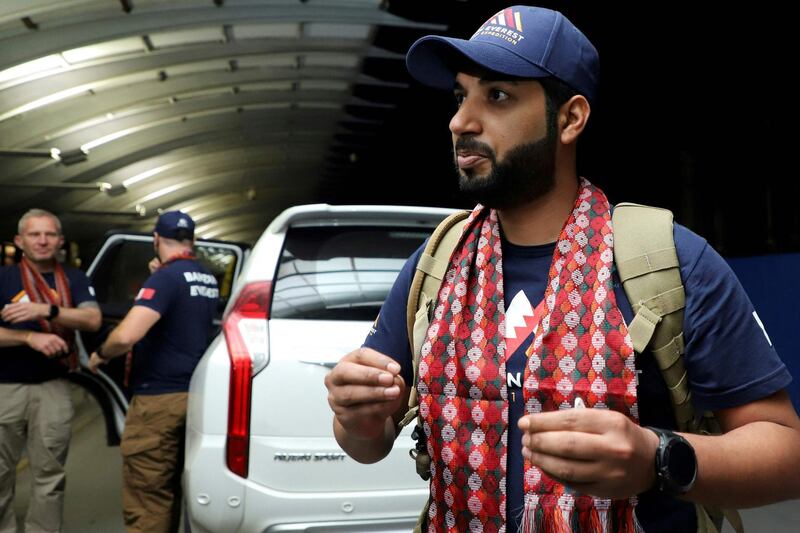 In this picture taken on March 15, 2021 Sheikh Mohamed Hamad Mohamed Al Khalifa (R), who is planning to climb the Mount Everest, arrives at Tribhuvan International Airport in Kathmandu. Nepal is investigating how a Bahraini prince planning to climb Mount Everest brought 2,000 coronavirus vaccine doses to the country without prior approval, authorities said. / AFP / NIshant S. GURUNG
