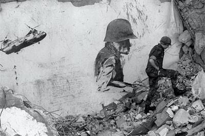 epa00804468 A file photograph from October 1983 shows a US Marine as he walks in the rubble of the marines headquarters follwoing the October 23 suicide bombing attack on the building in Beirut. Both the US Marines and French soldiers, both part of the international peacekeeping force in Lebanon were bombed on October 23, 1983 in what is suspected to be attacks by the Hezbollah suicide bombers, killing 58 French soldiers and 241 American servicemen. As UN Secretary General Kofi Annan continues his tour of the Middle East on Tuesday, 29 August 2006 arriving in Israel, French peacekeepers have returned to Lebanon as part of the UNIFIL force to help enforce UN resolution 1701 calling for a ceasefire between Israel and Hezbollah following their 34-day war.  EPA/JIM HOLLANDER (BLACK AND WHITE ONLY) *** Local Caption *** 00804468