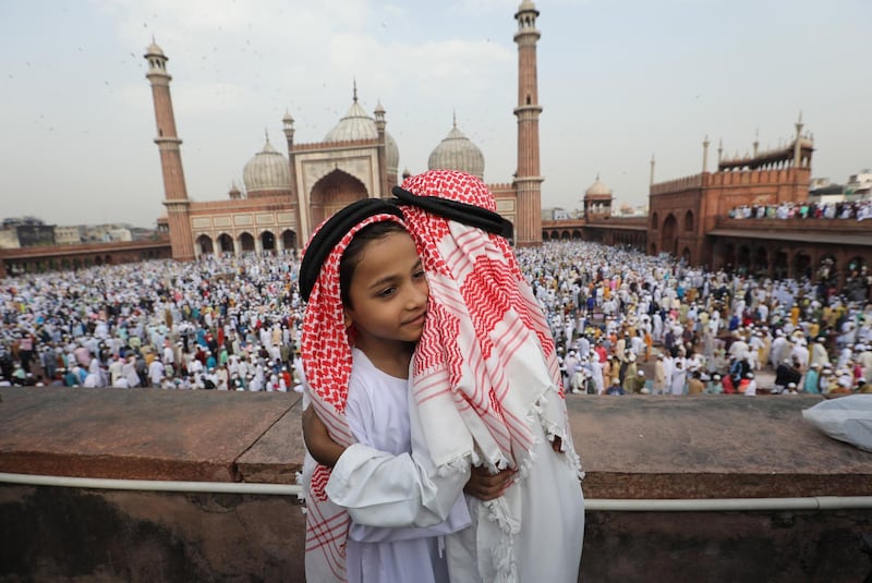 Indian Muslim children greet each offering prayers at Jama Masjid on the occasion of Eid-al-Fitr in New Delhi, India. EPA