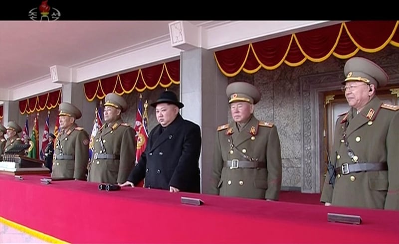 Kim Jong Un watches the military parade in Pyongyang. KRT / AP