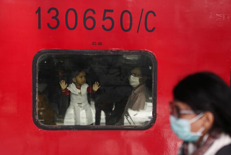 People wearing protective masks are seen at a railway station in Mumbai, India. REUTERS