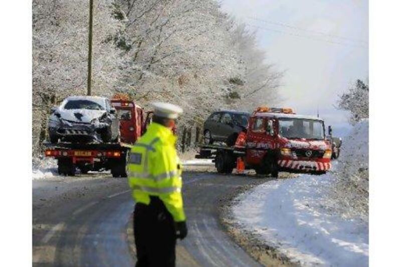 Vehicles are recovered after an accident on the snow covered A170 road near Helmsley, northern England. Nigel Roddis / Reuters