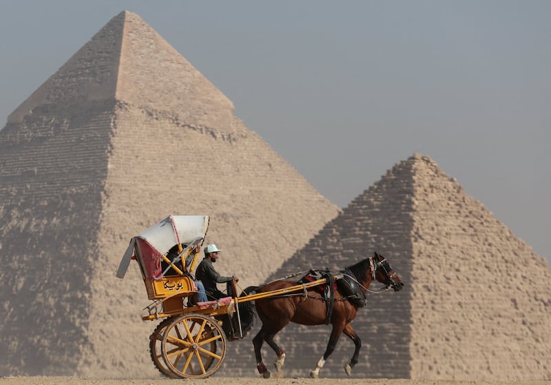 A horse-drawn cart in front of the plateau in Giza. Reuters