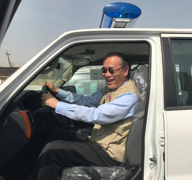 A handout picture released by the official Facebook page of the Embassy of Japan in Iraq on March 21, 2018 shows Japanese Ambassador Fumio Iwai riding in a pick-up truck during a handover ceremony of vehicles provided by Japan to the Iraqi police at an unspecified location in Iraq.
While foreign diplomats often struggle to win over ordinary Iraqis, Japan's ambassador has stolen hearts -- thanks to witty social media missives in classical Arabic and a range of local dialects. / AFP PHOTO / Facebook Page of the Embassy of Japan to Iraq / - / === RESTRICTED TO EDITORIAL USE - MANDATORY CREDIT "AFP PHOTO / HO / FACEBOOK PAGE OF THE EMBASSY OF JAPAN TO IRAQ' - NO MARKETING NO ADVERTISING CAMPAIGNS - DISTRIBUTED AS A SERVICE TO CLIENTS ==