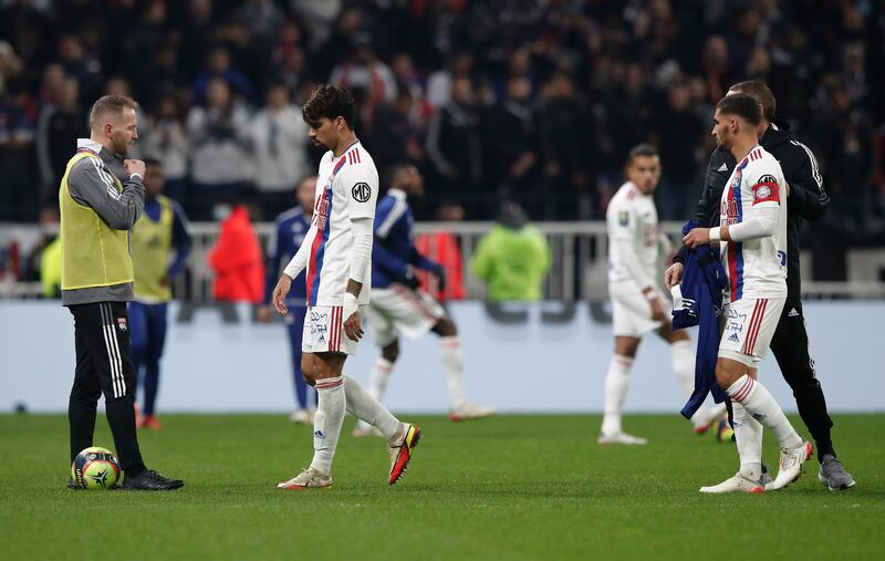 Lyon players return to the dressing room after Marseille's Dimitri Payet was hit by a water bottle thrown by a fan. Reuters