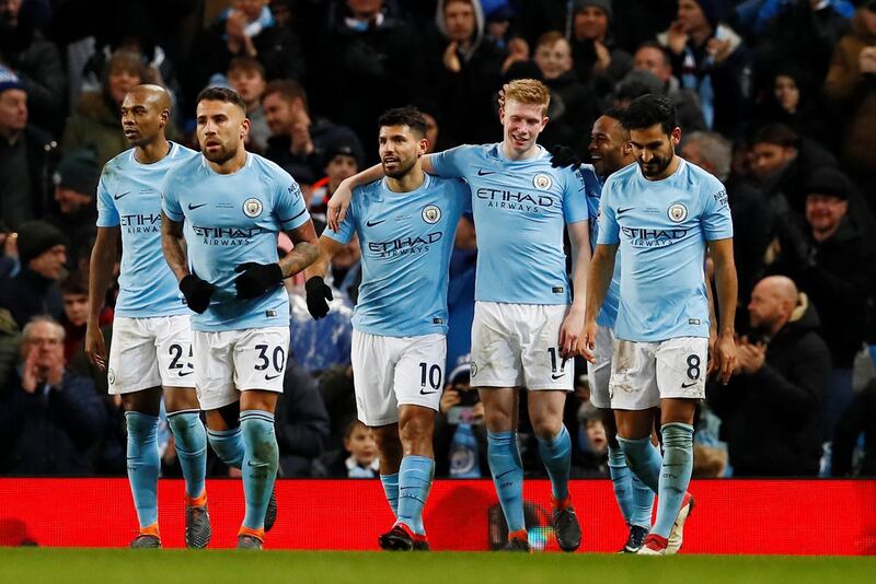 Soccer Football - Premier League - Manchester City vs Leicester City - Etihad Stadium, Manchester, Britain - February 10, 2018   Manchester City's Sergio Aguero celebrates scoring their third goal with Kevin De Bruyne and teammates   Action Images via Reuters/Jason Cairnduff    EDITORIAL USE ONLY. No use with unauthorized audio, video, data, fixture lists, club/league logos or "live" services. Online in-match use limited to 75 images, no video emulation. No use in betting, games or single club/league/player publications.  Please contact your account representative for further details.