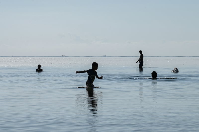 People swim in Puerto Princesa, Palawan. AFP