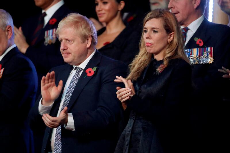 Prime Minister Boris Johnson and Carrie Symonds attend the annual Royal British Legion Festival of Remembrance at the Royal Albert Hall in London on November 9, 2019. AFP