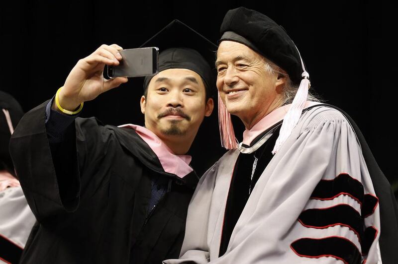 Just before receiving his degree, Berklee College of Music graduate Wing-Ching Poon of Edmonton, Canada takes a “selfie” with former Led Zeppelin guitarist Jimmy Page. Winslow Townson / AP photo