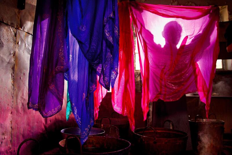 SHEKI (SHAKI), AZERBAIJAN - APRIL : April 18, 2012, Silk Factory, Sheki (Shaki), Azerbaijan. A worker in the silk factory hangs newly dyed silk cloths to dry. All of the dyes are made from natural sources, mostly plants. Sheki has been famous for its silk since ancient times. During Soviet rule, Sheki was the center of the silk industry and home to the Soviet Unions largest silk plant. (Photo by Reza/Getty Images)