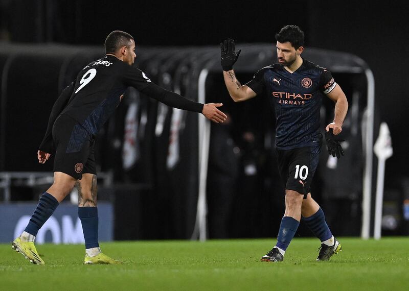Manchester City's Brazilian striker Gabriel Jesus (L) congratulates Manchester City's Argentinian striker Sergio Aguero after he scored their thrid goal during the English Premier League football match between Fulham and Manchester City at Craven Cottage in London on March 13, 2021. (Photo by Justin Setterfield / POOL / AFP) / RESTRICTED TO EDITORIAL USE. No use with unauthorized audio, video, data, fixture lists, club/league logos or 'live' services. Online in-match use limited to 120 images. An additional 40 images may be used in extra time. No video emulation. Social media in-match use limited to 120 images. An additional 40 images may be used in extra time. No use in betting publications, games or single club/league/player publications. / 