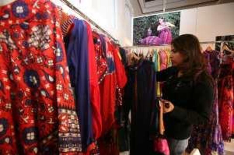 DUBAI, UNITED ARAB EMIRATES - JANUARY 18:  Indian designers are showcasing their upcoming collections to local buyers to promote Delhi Fashion Week, in the Bastakiya area of Dubai on January 18, 2009.  Pictured is Deepika Ghanwani looking at clothing by Preeti Chandra.  (Randi Sokoloff / The National)  For story by Surya. *** Local Caption ***  RS009-0118-Designers.jpg