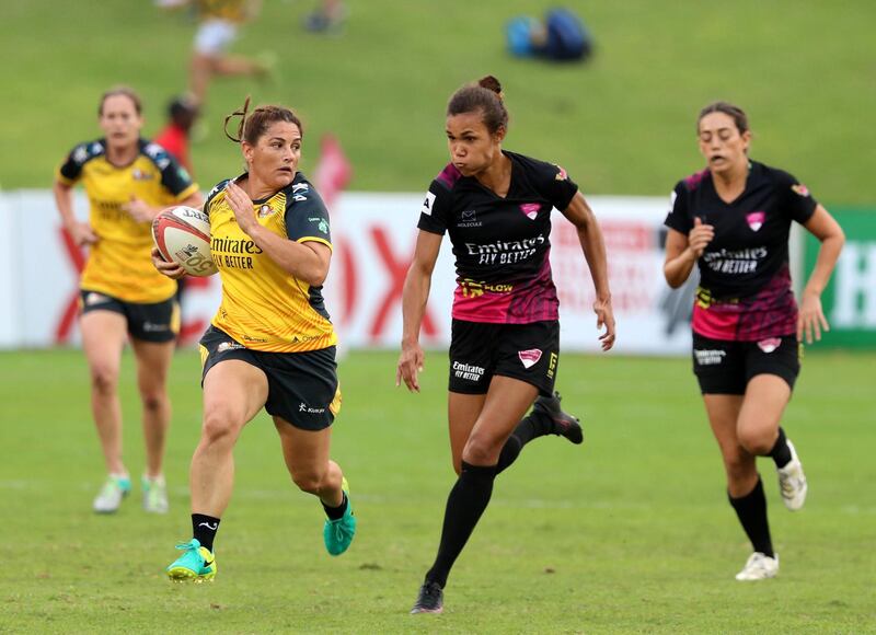 Dubai, United Arab Emirates - December 07, 2019: Bridie Johnson of Hurricanes beats the defence of the Emirates Firebirds Blue in the game between Dubai Hurricanes and Emirates Firebirds Blue in the Gulf womens final at the HSBC rugby sevens series 2020. Saturday, December 7th, 2019. The Sevens, Dubai. Chris Whiteoak / The National