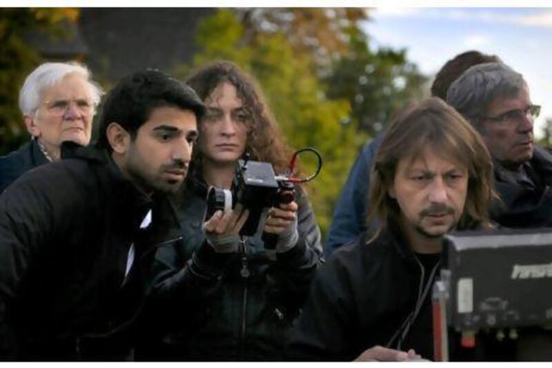 Abdulla Khalifa AlKaabi, left, the director, along with other crew, watch the shooting of The Philosopher. The film is one of the 14 competing for the Muhr Emirati award during the Dubai International Film Festival.