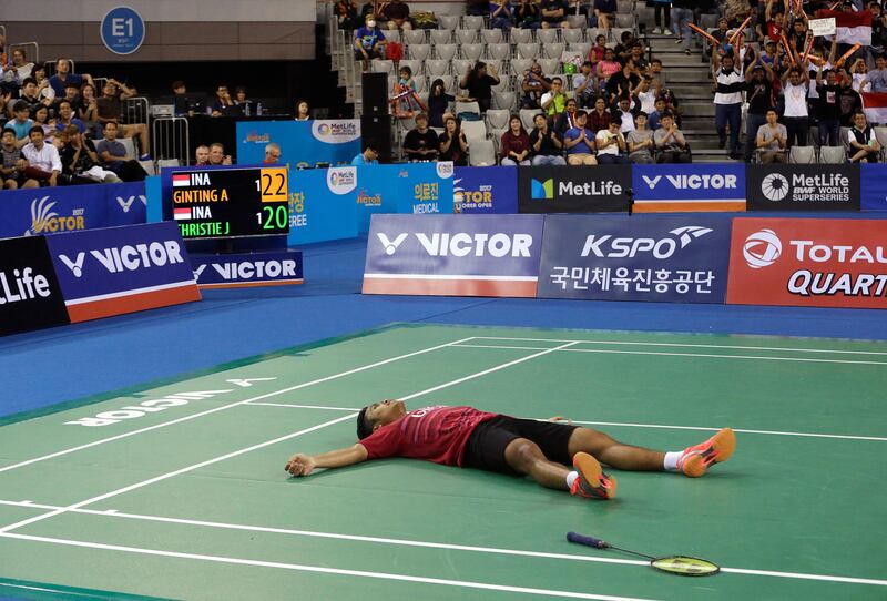 Indonesia's Anthony Sinisuka Ginting lies on the floor after winning against his compatriot Jonatan Christie during men's single final match at the Korea Open Badminton in Seoul, South Korea. Ahn Young-joon / AP Photo