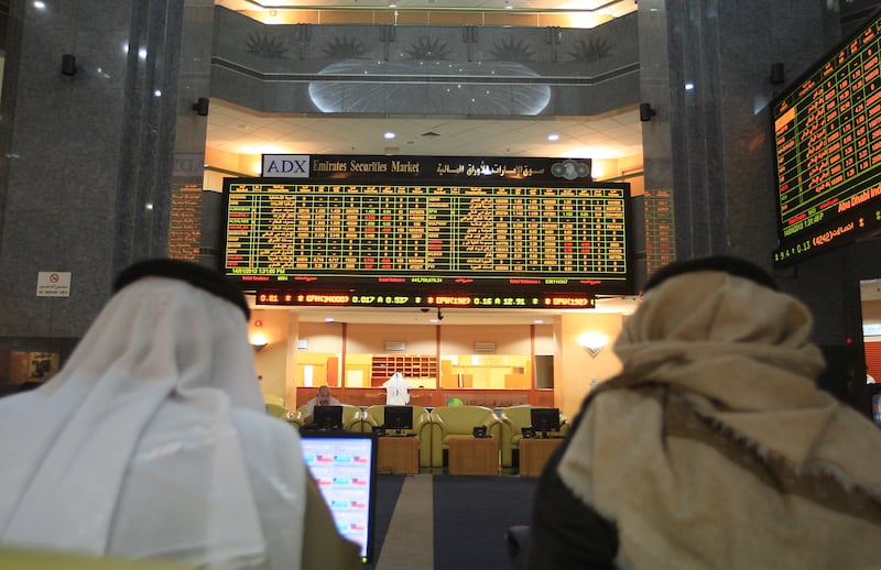 ABU DHABI - UNITED ARAB EMIRATES - 14JAN2013 - Share holders watch the display of share market at (ADX) Abu Dhabi Securities Exchange. Ravindranath K / The National 