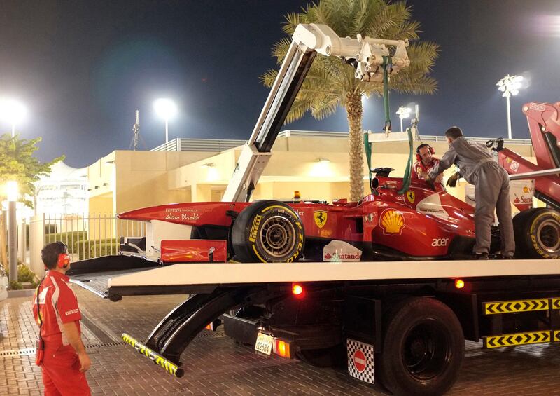 A tow truck carrying the car of Ferrari Formula One driver Fernando Alonso of Spain arrives to the pits after Alonso crashed during the second practice session of the Abu Dhabi F1 Grand Prix at Yas Marina circuit in Abu Dhabi November 11, 2011. REUTERS/Caren Firouz (UNITED ARAB EMIRATES - Tags: SPORT MOTORSPORT) *** Local Caption ***  ABD24_MOTOR-RACING-_1111_11.JPG