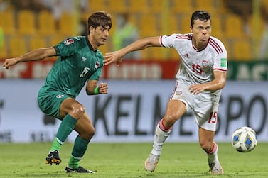 UAE's forward Fabio Lima (R) is marked by Iraq's forward Mohanad Ali during the 2022 Qatar World Cup Asian Qualifiers football match between United Arab Emirates and Iraq, at the Zabeel stadium in Dubai, on October 12, 2021.  (Photo by -  /  AFP)