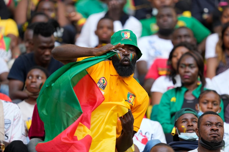 A Cameroon fan dances before the match. AP