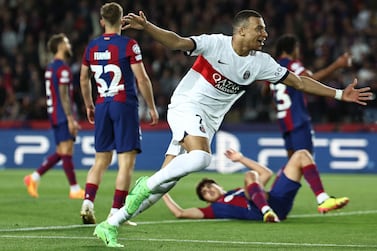 Paris Saint-Germain's French forward #07 Kylian Mbappe celebrates scoring his team's third goal from the penalty spot during the UEFA Champions League quarter-final second leg football match between FC Barcelona and Paris SG at the Estadi Olimpic Lluis Companys in Barcelona on April 16, 2024.  (Photo by FRANCK FIFE  /  AFP)