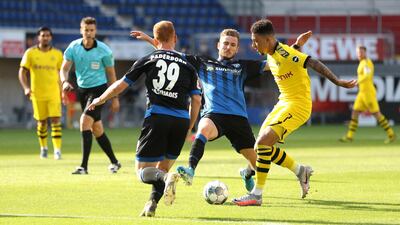 PADERBORN, GERMANY - MAY 31: Jadon Sancho of Borussia Dortmund battles for the ball with Dennis Srbeny and Jamilu Collins of Sport-Club Paderborn during the Bundesliga match between SC Paderborn 07 and Borussia Dortmund at Benteler Arena on May 31, 2020 in Paderborn, Germany. (Photo by Lars Baron/Getty Images)