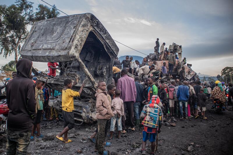 Residents dismantle a UN vehicle torched in Kanyaruchinya  in the Democratic Republic of Congo, in November. AFP