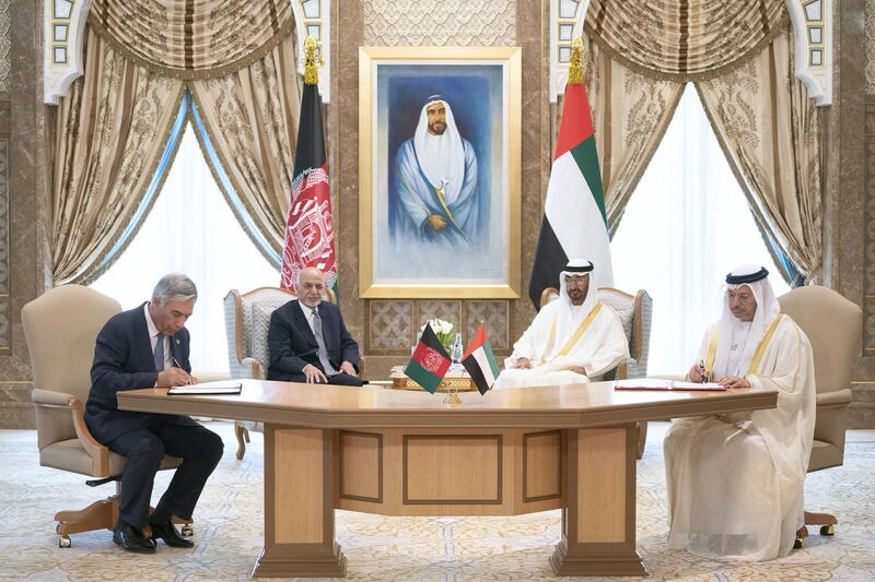 ABU DHABI, UNITED ARAB EMIRATES - March 17, 2019: HH Sheikh Mohamed bin Zayed Al Nahyan Crown Prince of Abu Dhabi Deputy Supreme Commander of the UAE Armed Forces (back centre R) and HE Ashraf Ghani, President of Afghanistan (back centre L), witness the signing of a memorandum of understanding pertaining to mining, energy, education and sports sectors between the UAE and Afghanistan. Seen signing are HE Dr Anwar bin Mohamed Gargash, UAE Minister of State for Foreign Affairs (R) and HE Humayun Qayoumi, Minister of Finance of Afghanistan (L), at the Presidential Palace.
( Ryan Carter / Ministry of Presidential Affairs )