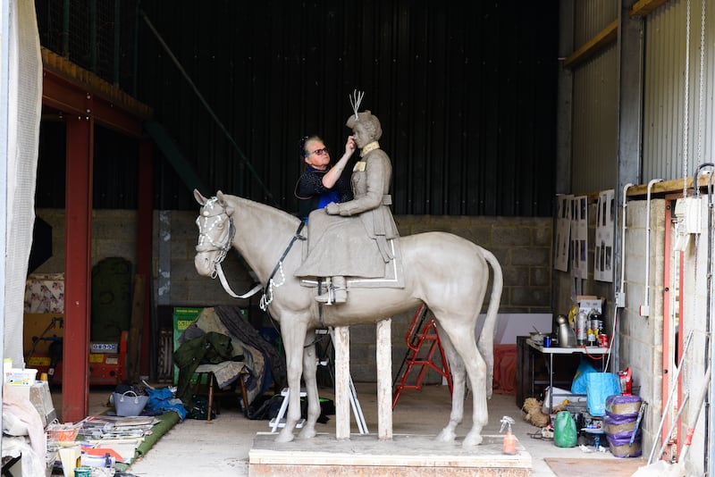 Sculptor Caroline Wallace works on a sculpture of Queen Elizabeth II riding the horse Burmese, which will be installed at the Royal Military Academy Sandhurst. Photo: Miranda Meiklejohn