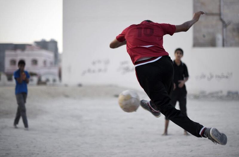 Bahraini boys play football in the village of Barbar, west of the capital Manama. Mohammed Al-Shaikh / AFP 