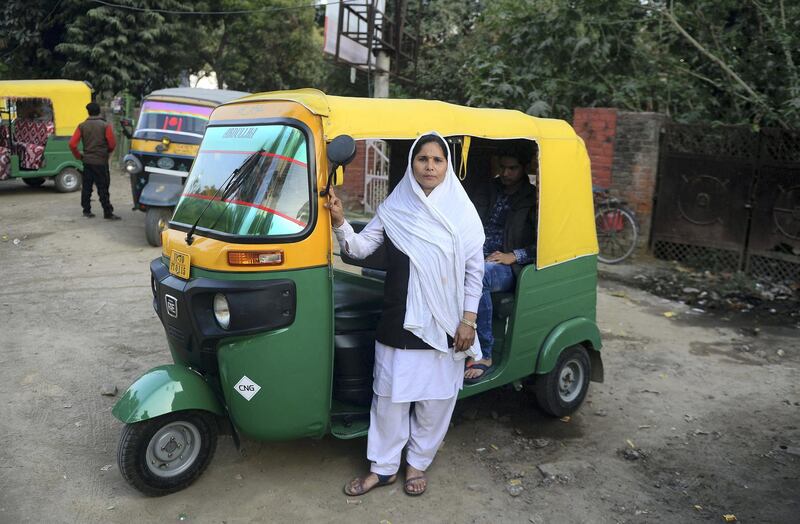 To mark the occasion of International Women's Day on March 8, 2018 AFP presents a series of 45 photos depicting women performing roles or working in professions more traditionally held by men.  More images can be found in www.afpforum.com  Search SLUG  "WOMEN-DAY -PACKAGE". 
Tabasumm, 30, an auto-rickshaw driver, poses with her vehicle in Allahabad on February 22, 2018.

In the ring, battling flames or lifting off into space, women have entered professions generally considered as men's jobs. For International Women's Day, AFP met with women breaking down the barriers of gender-bias in the work world. / AFP PHOTO / SANJAY KANOJIA