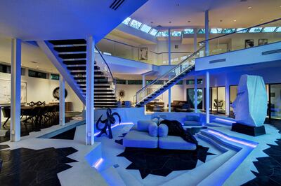 Blue strip lighting gives the sunken living area an otherworldly feel. Courtesy Martha Turner Sotheby's International Realty