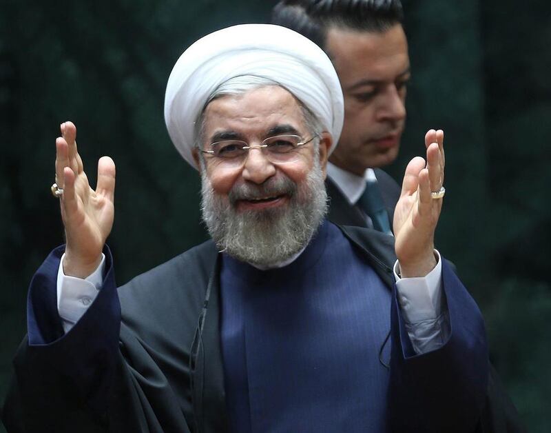 Iranian President Hassan Rouhani salutes before addressing a Turkish-Iranian business forum in Ankara on June 10, 2014. Adem Altan / AFP 

