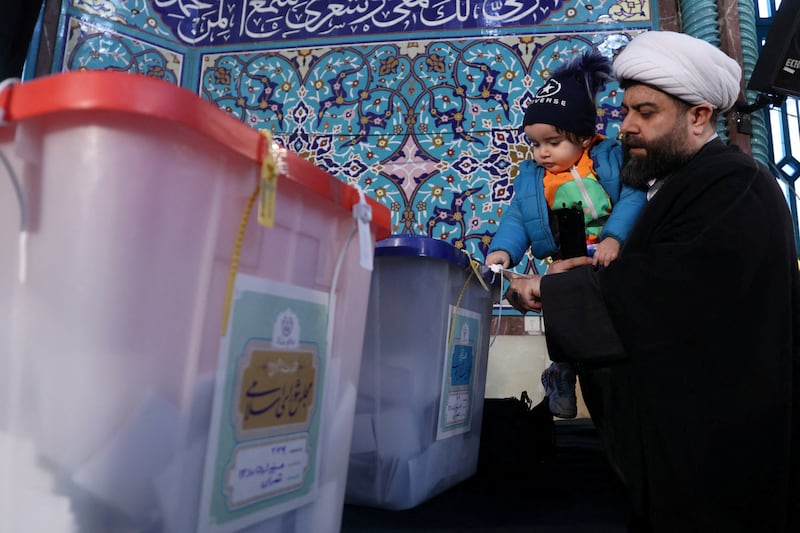 An Iranian cleric casts his vote during parliamentary elections at a polling station in Tehran on Friday. Reuters