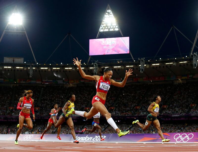 United States'  Allyson Felix, second from right, crosses the finish line to win gold ahead of Jamaica's Shelly-Ann Fraser-Pryce, right, in the women's 200-meter final during the athletics in the Olympic Stadium at the 2012 Summer Olympics, London, Wednesday, Aug. 8, 2012. (AP Photo/Matt Dunham)