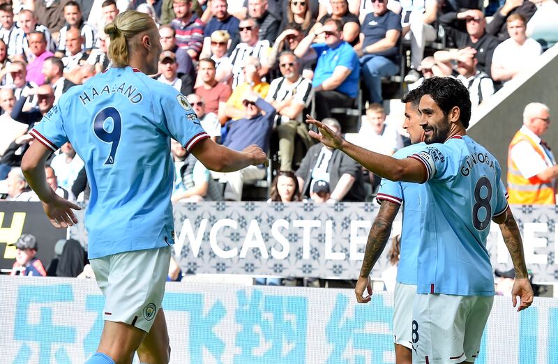 Ilkay Gundogan celebrates with teammate Erling Haaland. EPA