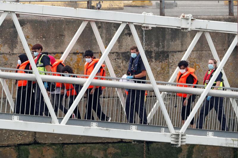 Migrants disembark after arriving at Dover harbour, in Dover, Britain August 12, 2020. REUTERS/Matthew Childs