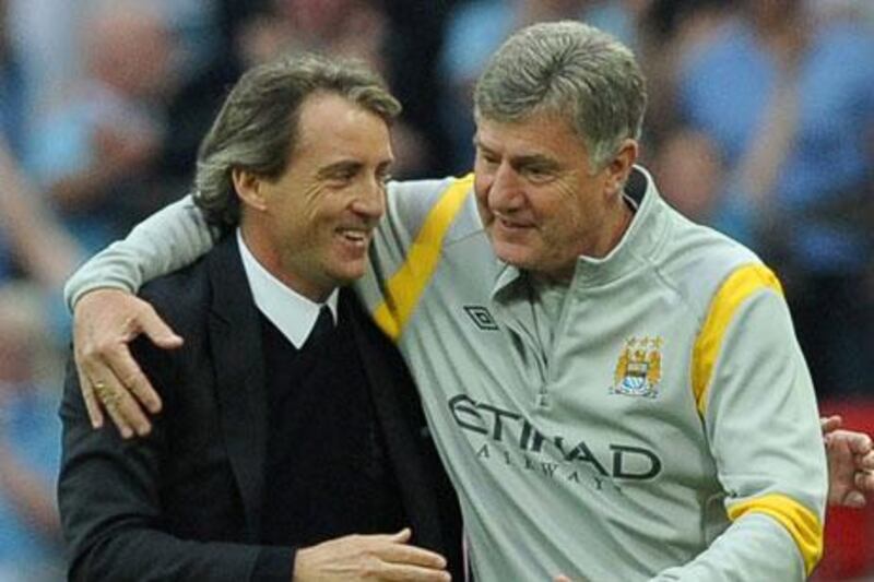 Roberto Mancini celebrates with assistant manager Brian Kidd