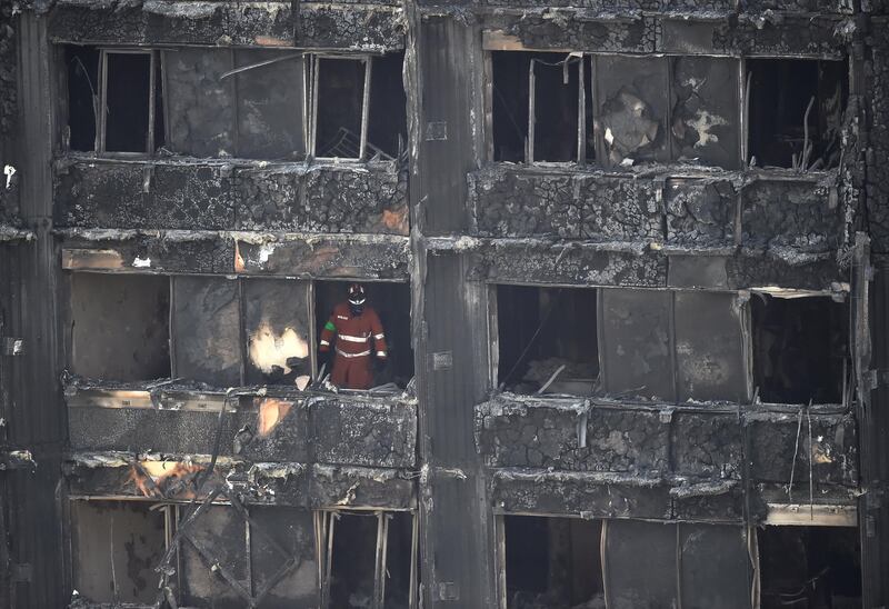 A member of the emergency services works inside the Grenfell apartment tower block in North Kensington, London, Britain, June 17, 2017. REUTERS/Hannah McKay