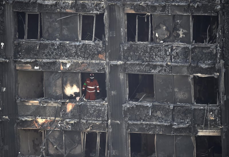 A member of the emergency services works inside the Grenfell apartment tower block in North Kensington, London, Britain, June 17, 2017. REUTERS/Hannah McKay